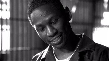 Movie still from “American History X” (1998), directed by Tony Kaye – A black and white photo of a man smiling; Close Up shot, Low angle