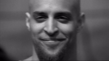 Movie still from “American History X” (1998), directed by Tony Kaye – A black and white photo of a man's face; Extreme Close Up shot, Low angle