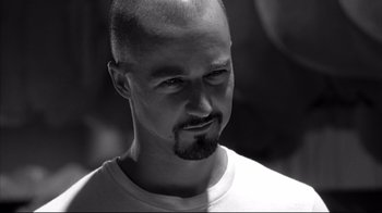 Movie still from “American History X” (1998), directed by Tony Kaye – Black and white photograph of a man with a bald head; Close Up shot, Low angle