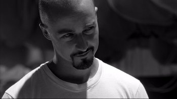 Movie still from “American History X” (1998), directed by Tony Kaye – Black and white photograph of a man with a shaved head; Close Up shot, Low angle