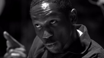 Movie still from “American History X” (1998), directed by Tony Kaye – A black and white photo of a man with a serious look on his face; Close Up shot, Low angle