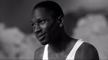 Movie still from “American History X” (1998), directed by Tony Kaye – A black and white photo of a man in a white tank top; Close Up shot, Low angle
