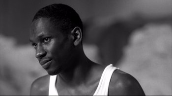 Movie still from “American History X” (1998), directed by Tony Kaye – A black and white photo of a man looking at the camera; Close Up shot, Low angle