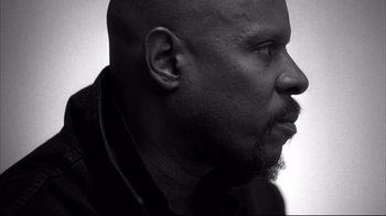 Movie still from “American History X” (1998), directed by Tony Kaye – A black and white photo of a man's face; Close Up shot, Low angle