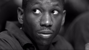 Movie still from “American History X” (1998), directed by Tony Kaye – A black and white photo of a man's face; Close Up shot, Low angle
