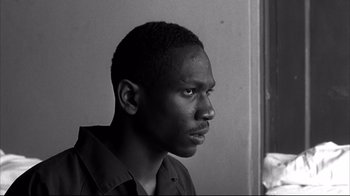 Movie still from “American History X” (1998), directed by Tony Kaye – A black and white photo of a man looking at the camera; Close Up shot, Low angle