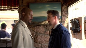 Movie still from “American History X” (1998), directed by Tony Kaye – Two men standing next to each other in front of a painting; Medium shot, Low angle