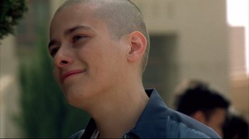Movie still from “American History X” (1998), directed by Tony Kaye – A man with a shaved head is looking up; Close Up shot, Over the shoulder angle