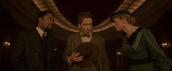 Movie still from “Amsterdam” (2022), directed by David O. Russell – A group of people standing next to each other in a room; Medium shot, Low angle