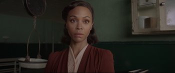 Movie still from “Amsterdam” (2022), directed by David O. Russell – An image of a woman in a red jacket; Close Up shot, Over the shoulder angle