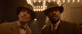 Movie still from “Amsterdam” (2022), directed by David O. Russell – A couple of men standing next to each other wearing hats; Close Up shot, Low angle
