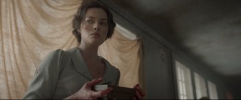 Movie still from “Amsterdam” (2022), directed by David O. Russell – A woman holding a piece of paper in her hands; Medium shot, Over the shoulder angle