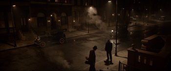 Movie still from “Amsterdam” (2022), directed by David O. Russell – Two men are walking down the street at night; Extreme Wide shot, High angle