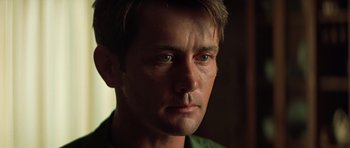 Movie still from “Apocalypse Now” (1979), directed by Francis Ford Coppola – A person with a green shirt on; Close Up shot, Low angle