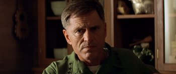 Movie still from “Apocalypse Now” (1979), directed by Francis Ford Coppola – A person wearing a green shirt; Close Up shot, Low angle