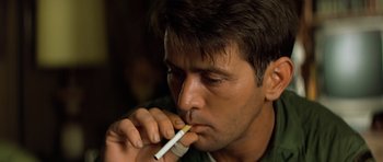 Movie still from “Apocalypse Now” (1979), directed by Francis Ford Coppola – A person holding a cigarette in his mouth; Close Up shot, Low angle