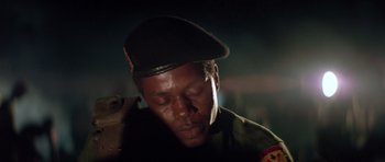 Movie still from “Apocalypse Now” (1979), directed by Francis Ford Coppola – A man wearing a military uniform and a hat; Close Up shot, Low angle