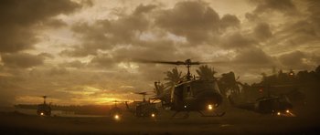 Movie still from “Apocalypse Now” (1979), directed by Francis Ford Coppola – A group of helicopters flying in the sky at sunset; Extreme Wide shot, Low angle
