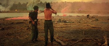 Movie still from “Apocalypse Now” (1979), directed by Francis Ford Coppola – Two men standing in the sand looking at a body of water; Extreme Wide shot, Low angle