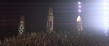 Movie still from “Apocalypse Now” (1979), directed by Francis Ford Coppola – A crowd of people standing in front of a rocket at night; Extreme Wide shot, Low angle