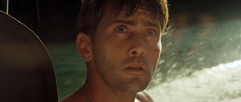 Movie still from “Apocalypse Now” (1979), directed by Francis Ford Coppola – A man's face in front of a waterfall; Close Up shot, Low angle