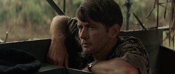 Movie still from “Apocalypse Now” (1979), directed by Francis Ford Coppola – A person leaning on a wall; Close Up shot, Over the shoulder angle
