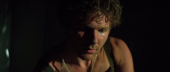 Movie still from “Apocalypse Now” (1979), directed by Francis Ford Coppola – A man's face in the dark; Close Up shot, Low angle