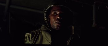 Movie still from “Apocalypse Now” (1979), directed by Francis Ford Coppola – A man wearing a helmet in a dark room; Close Up shot, Low angle