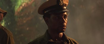 Movie still from “Apocalypse Now” (1979), directed by Francis Ford Coppola – A man in a military uniform wearing a hat; Close Up shot, Low angle
