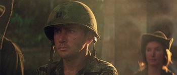 Movie still from “Apocalypse Now” (1979), directed by Francis Ford Coppola – A man in a military uniform wearing a helmet; Close Up shot, Low angle
