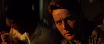 Movie still from “Apocalypse Now” (1979), directed by Francis Ford Coppola – A man's face in the dark; Close Up shot, Over the shoulder angle