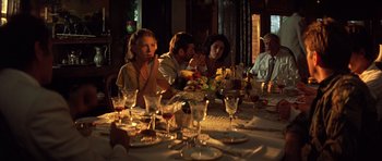 Movie still from “Apocalypse Now” (1979), directed by Francis Ford Coppola – A group of people sitting around a dinner table; Medium shot, High angle