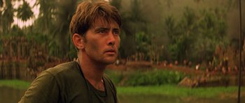 Movie still from “Apocalypse Now” (1979), directed by Francis Ford Coppola – A person wearing a green shirt; Close Up shot, Low angle