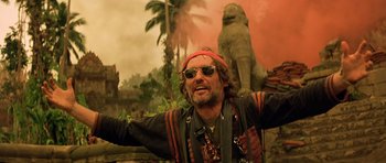 Movie still from “Apocalypse Now” (1979), directed by Francis Ford Coppola – A man with a red bandana on his head and sunglasses on; Medium shot, Low angle