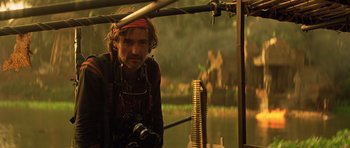 Movie still from “Apocalypse Now” (1979), directed by Francis Ford Coppola – A man with a beard and a red bandanna is holding a camera; Medium shot, Low angle