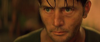 Movie still from “Apocalypse Now” (1979), directed by Francis Ford Coppola – A man's face with blue eyes; Close Up shot, Low angle
