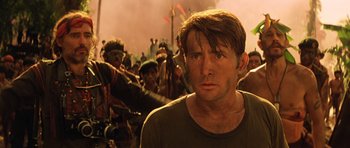 Movie still from “Apocalypse Now” (1979), directed by Francis Ford Coppola – A person with a crowd in the background; Close Up shot, Low angle