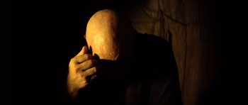 Movie still from “Apocalypse Now” (1979), directed by Francis Ford Coppola – A person with their head in their hands; Close Up shot, High angle