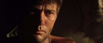 Movie still from “Apocalypse Now” (1979), directed by Francis Ford Coppola – A man's face in the dark; Close Up shot, Low angle
