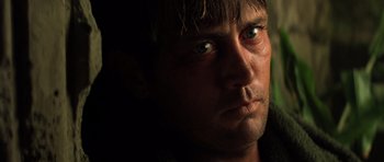 Movie still from “Apocalypse Now” (1979), directed by Francis Ford Coppola – A man's face in the dark; Close Up shot, Low angle