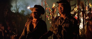 Movie still from “Apocalypse Now” (1979), directed by Francis Ford Coppola – A couple of men standing next to each other; Medium shot, Low angle