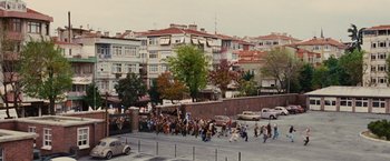 Movie still from “Argo” (2012), directed by Ben Affleck – A group of people walking down a street; Extreme Wide shot, High angle