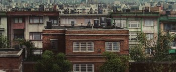 Movie still from “Argo” (2012), directed by Ben Affleck – A view of a bunch of buildings in a city; Extreme Wide shot, Overhead angle
