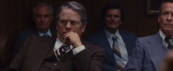 Movie still from “Argo” (2012), directed by Ben Affleck – A man in a suit and tie sitting in front of another man; Close Up shot, Over the shoulder angle
