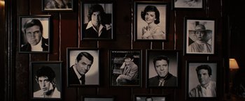 Movie still from “Argo” (2012), directed by Ben Affleck – A group of black - and - white photographs of people hanging on a wall; Close Up shot, High angle