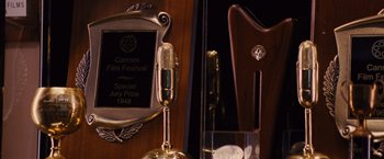 Movie still from “Argo” (2012), directed by Ben Affleck – A microphone is on display in front of a trophy; Extreme Close Up shot, High angle