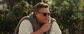 Movie still from “Argo” (2012), directed by Ben Affleck – A person wearing sunglasses and holding a cell phone; Close Up shot, Low angle