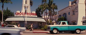 Movie still from “Argo” (2012), directed by Ben Affleck – A man walking down the street in front of a building; Extreme Wide shot, Low angle