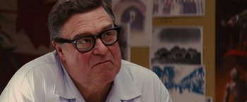 Movie still from “Argo” (2012), directed by Ben Affleck – An older man wearing glasses and a white dress shirt; Close Up shot, Low angle