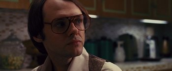 Movie still from “Argo” (2012), directed by Ben Affleck – A person wearing glasses; Close Up shot, Low angle